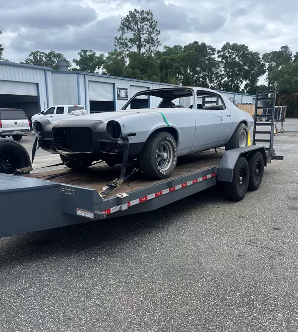 Classic Camaro project car loaded on Grace and Grit car hauler trailer